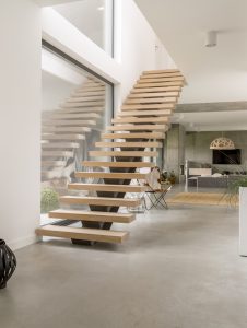 Wooden minimalistic stairs in pure big space