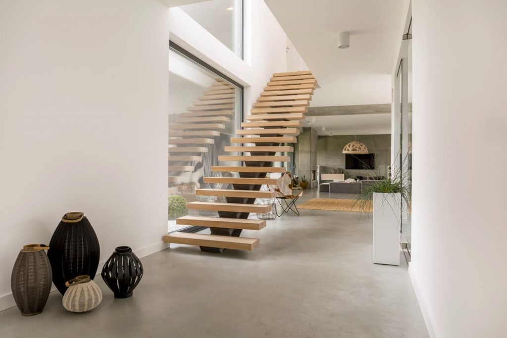 Wooden minimalistic stairs in pure big space