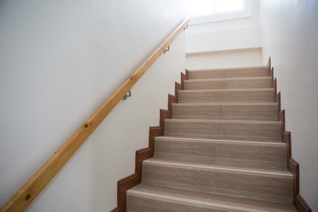 A straight staircase leading up to another floor