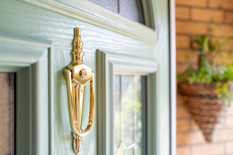 A door handle on a green door