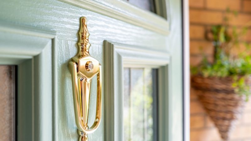 A door handle on a green door