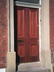 wooden door with raised and fielded panels