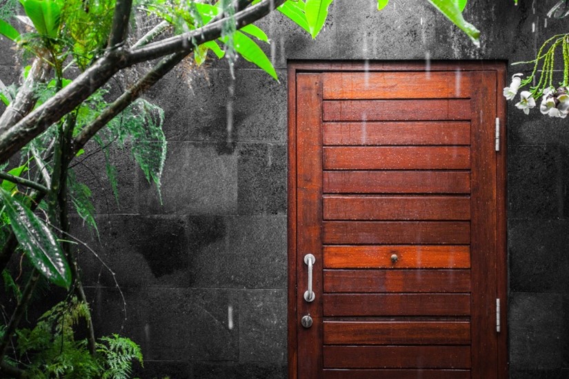 wooden front door in the rain