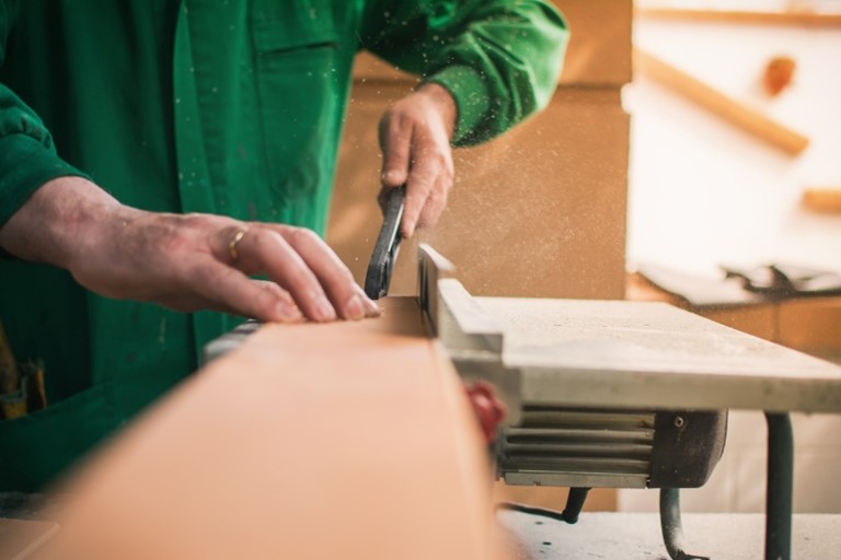 a joiner cutting a piece of wood