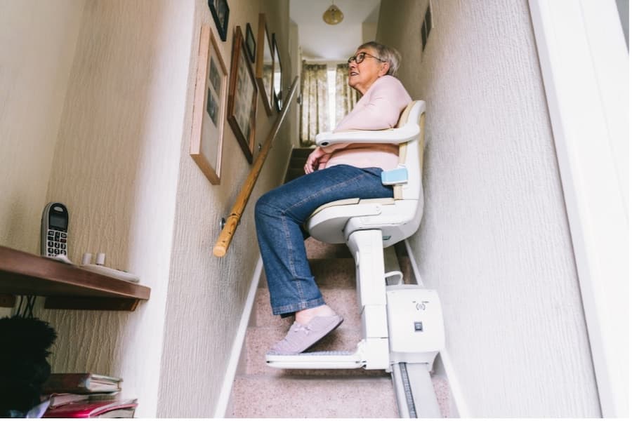 A person sitting on a stair lift