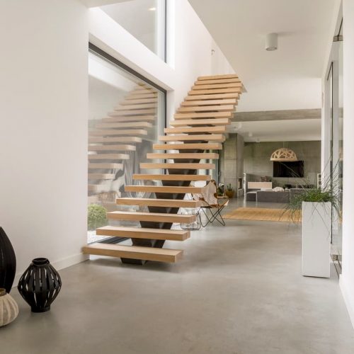 Wooden minimalistic stairs in pure big space